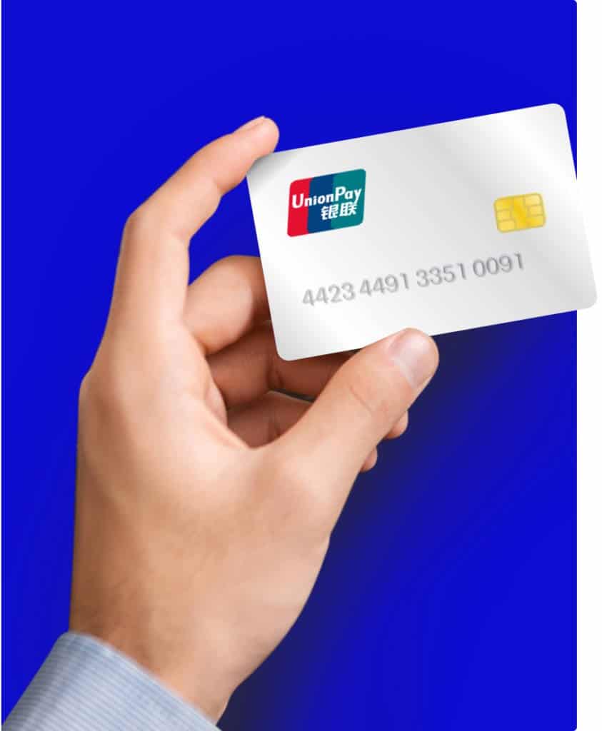 A hand holding a credit card